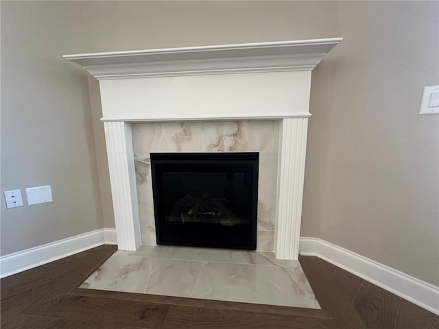 details featuring baseboards and a fireplace