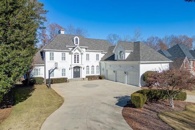 view of front of home featuring a garage and a front lawn