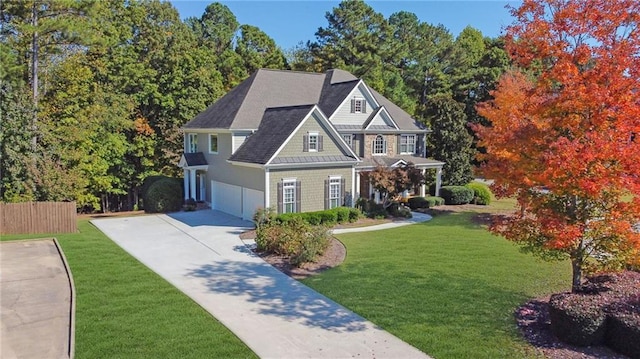 view of front of property featuring a front lawn and a garage