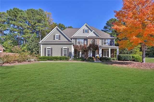 view of front of house with a porch and a front lawn