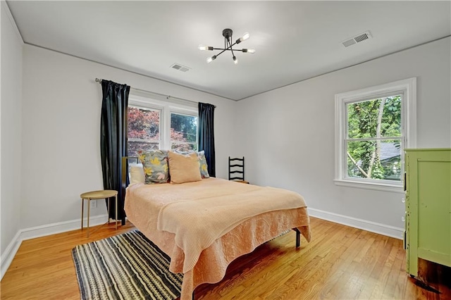 1544 Brewer Blvd SW, Atlanta, GA 30310 - bedroom featuring light wood-type flooring, baseboards, and a chandelier