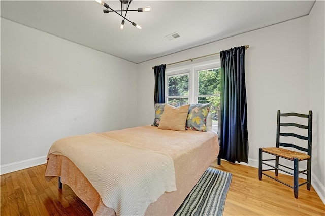1544 Brewer Blvd SW, Atlanta, GA 30310 - bedroom with baseboards, light wood-style flooring, and a chandelier