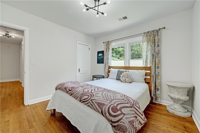 1544 Brewer Blvd SW, Atlanta, GA 30310 - bedroom featuring a chandelier, light wood-style flooring, and baseboards