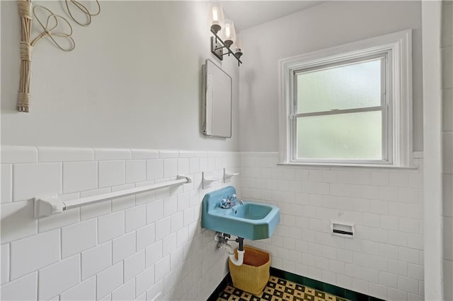 1544 Brewer Blvd SW, Atlanta, GA 30310 - bathroom with tile walls, a sink, and a wainscoted wall