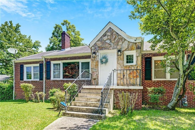 1544 Brewer Blvd SW, Atlanta, GA 30310 - view of front of property featuring a front yard, a chimney, stone siding, and brick siding