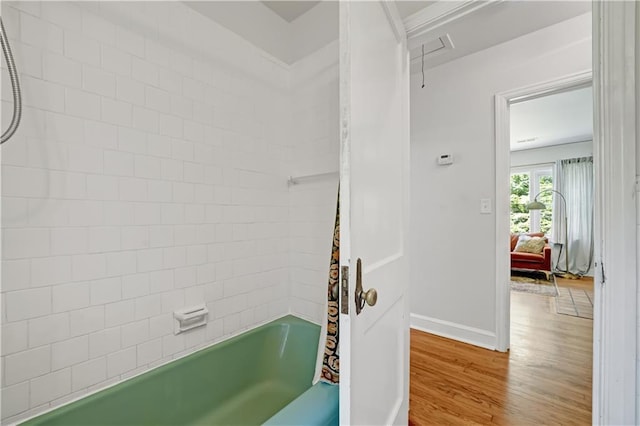 1544 Brewer Blvd SW, Atlanta, GA 30310 - bathroom featuring wood finished floors, shower / bath combo, and baseboards