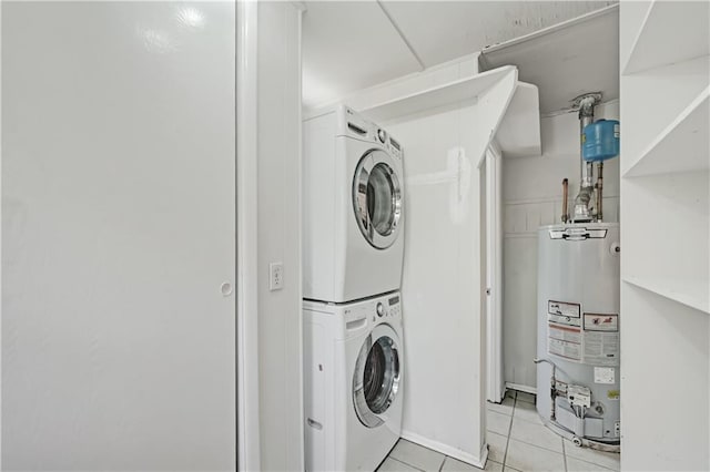 1544 Brewer Blvd SW, Atlanta, GA 30310 - laundry room featuring water heater, stacked washer / drying machine, and light tile patterned floors