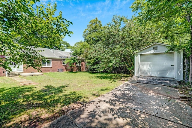 1544 Brewer Blvd SW, Atlanta, GA 30310 - view of green lawn with concrete driveway, an outbuilding, and a detached garage