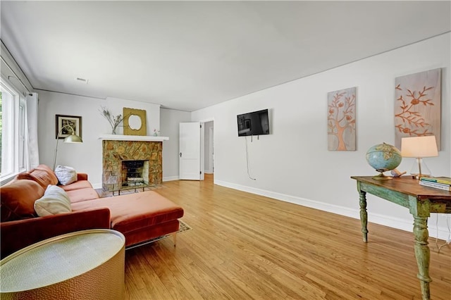 1544 Brewer Blvd SW, Atlanta, GA 30310 - living room featuring light wood-style floors, baseboards, and a fireplace