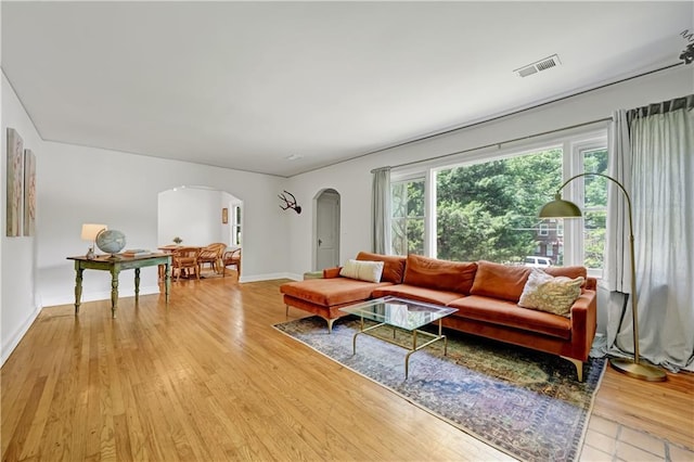 1544 Brewer Blvd SW, Atlanta, GA 30310 - living area with arched walkways, light wood-style floors, and baseboards