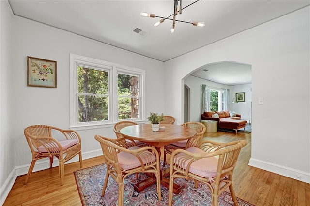 1544 Brewer Blvd SW, Atlanta, GA 30310 - dining room with arched walkways, light wood-style flooring, baseboards, and a chandelier