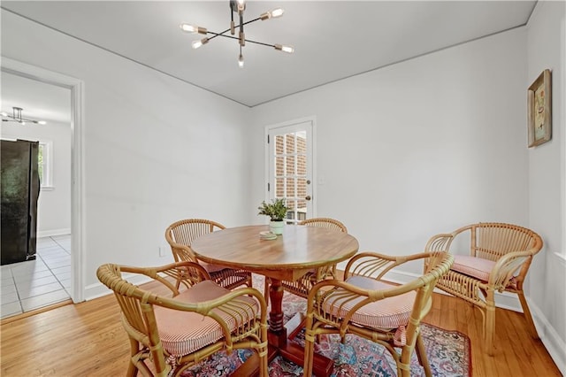1544 Brewer Blvd SW, Atlanta, GA 30310 - dining area featuring a chandelier, baseboards, and light wood-type flooring