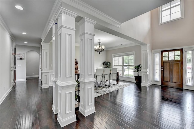 5770 Bridleton Xing, Suwanee, GA 30024 - foyer entrance with dark wood-type flooring, decorative columns, recessed lighting, a chandelier, and crown molding