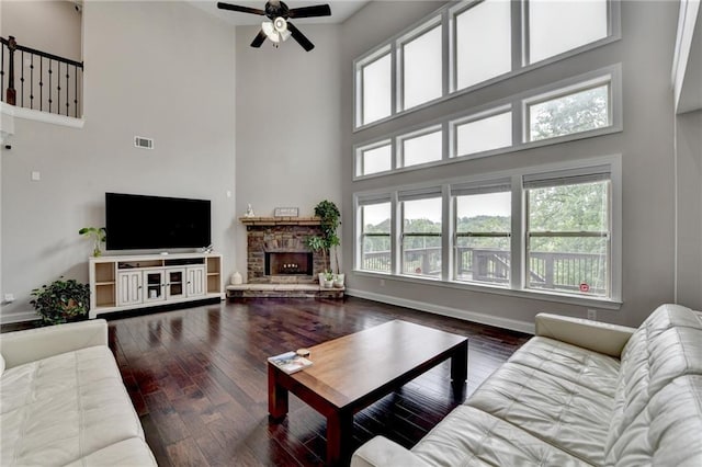 5770 Bridleton Xing, Suwanee, GA 30024 - living room with a high ceiling, a ceiling fan, wood finished floors, plenty of natural light, and a fireplace