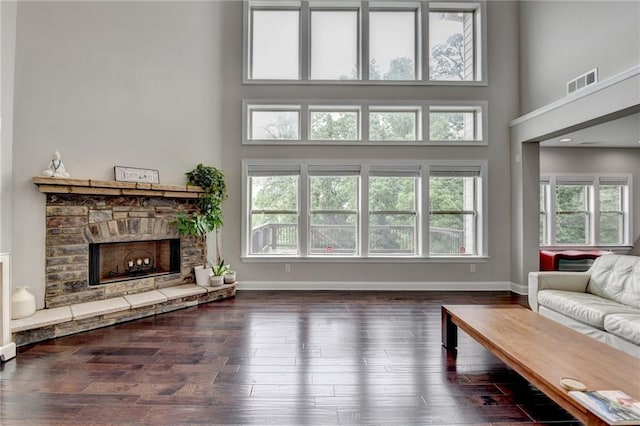 5770 Bridleton Xing, Suwanee, GA 30024 - living area featuring a high ceiling, a fireplace, wood finished floors, and baseboards