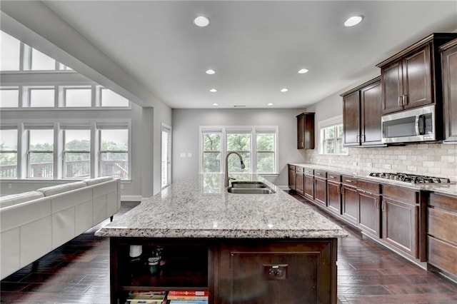 5770 Bridleton Xing, Suwanee, GA 30024 - kitchen with a sink, appliances with stainless steel finishes, open shelves, recessed lighting, and light stone countertops