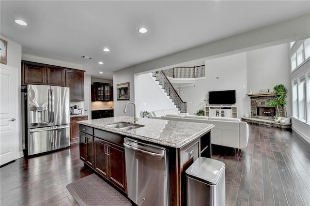 5770 Bridleton Xing, Suwanee, GA 30024 - kitchen featuring stainless steel appliances, a sink, dark wood finished floors, light stone countertops, and recessed lighting
