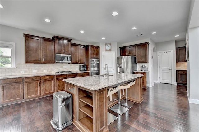 5770 Bridleton Xing, Suwanee, GA 30024 - kitchen with stainless steel appliances, a sink, open shelves, dark wood-style floors, and backsplash