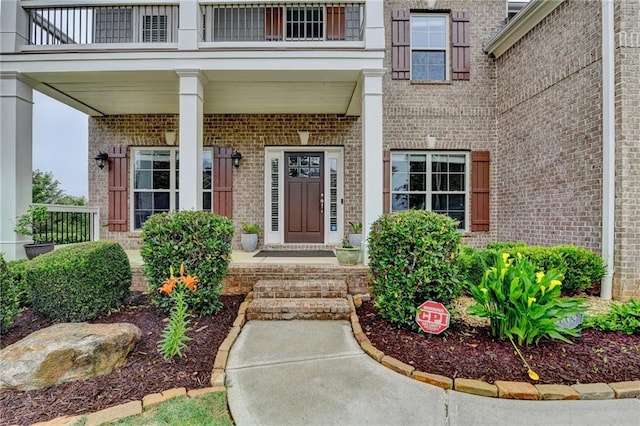 5770 Bridleton Xing, Suwanee, GA 30024 - property entrance featuring brick siding and a balcony