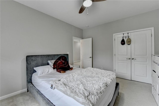 5770 Bridleton Xing, Suwanee, GA 30024 - bedroom with light carpet, ceiling fan, a closet, and baseboards