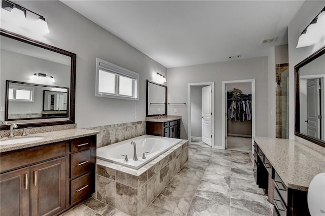5770 Bridleton Xing, Suwanee, GA 30024 - full bath featuring a shower stall, two vanities, a bath, and a walk in closet