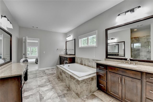 5770 Bridleton Xing, Suwanee, GA 30024 - full bathroom with plenty of natural light, a bath, a shower stall, and two vanities