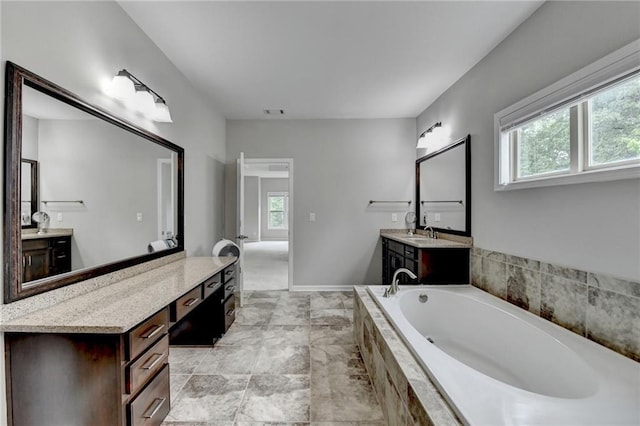 5770 Bridleton Xing, Suwanee, GA 30024 - bathroom featuring plenty of natural light, a garden tub, and two vanities