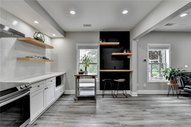 5770 Bridleton Xing, Suwanee, GA 30024 - kitchen featuring stainless steel electric range, open shelves, recessed lighting, white cabinetry, and light wood-style flooring