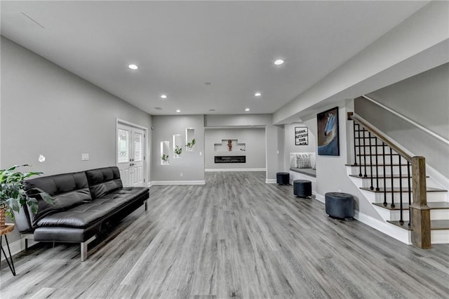 5770 Bridleton Xing, Suwanee, GA 30024 - living area with wood finished floors, stairs, recessed lighting, baseboards, and french doors