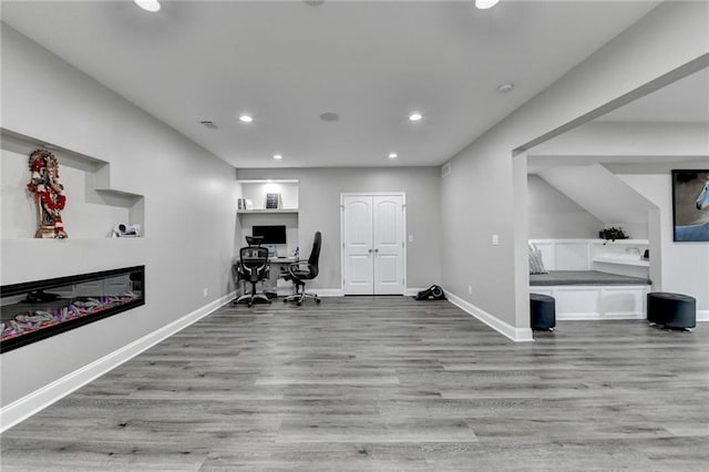 5770 Bridleton Xing, Suwanee, GA 30024 - home office with recessed lighting, a glass covered fireplace, wood finished floors, and baseboards