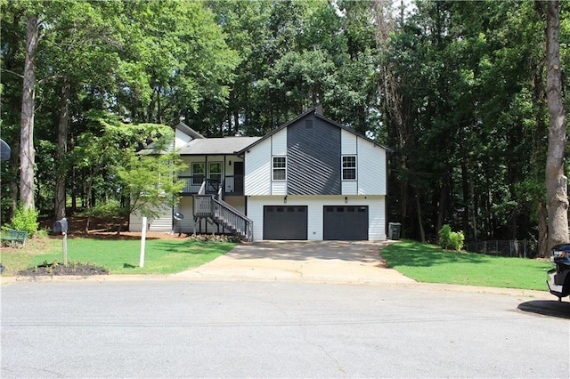 view of front of house with a garage and a front lawn