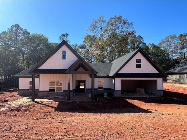 view of front of house with a garage and stone siding