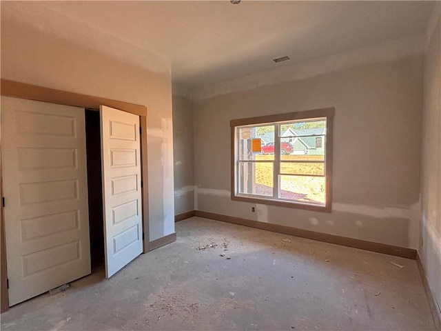 unfurnished bedroom with baseboards and visible vents