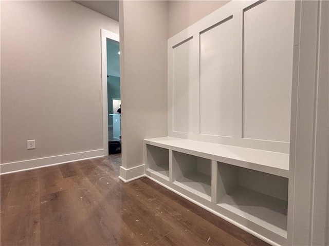 mudroom featuring baseboards and dark wood finished floors