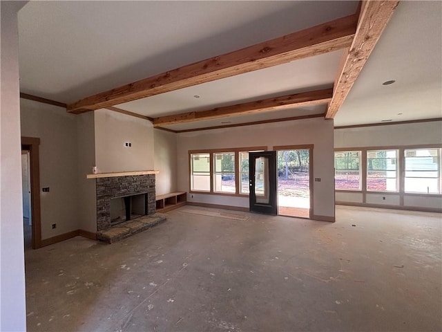 unfurnished living room featuring a fireplace, beam ceiling, and baseboards