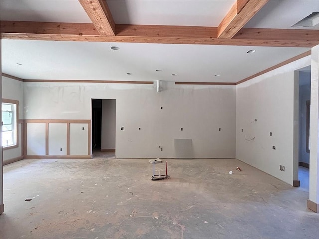 unfurnished room with beam ceiling and crown molding