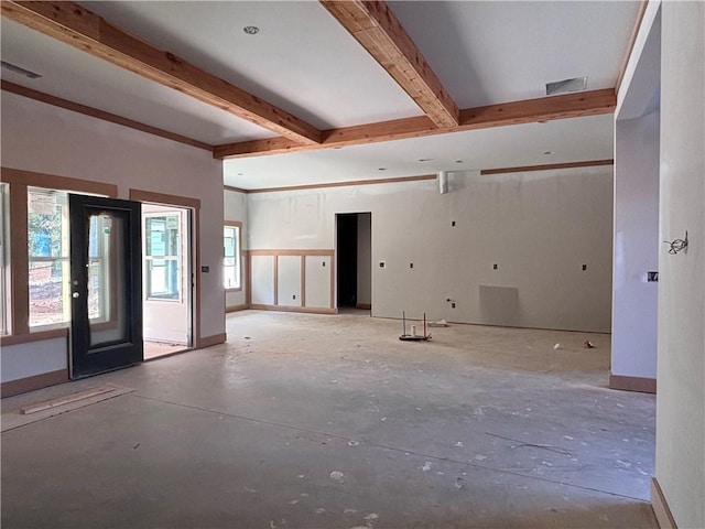 unfurnished room with visible vents, baseboards, and beam ceiling