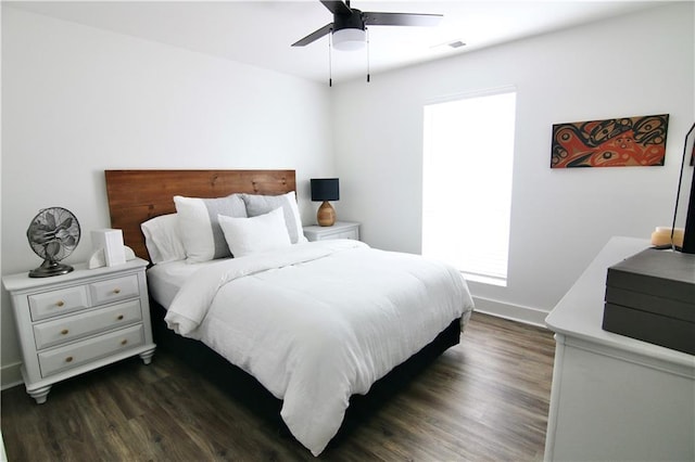 bedroom featuring wood finished floors, baseboards, and ceiling fan