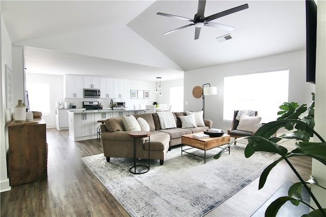 living room featuring high vaulted ceiling, dark wood-style floors, and ceiling fan