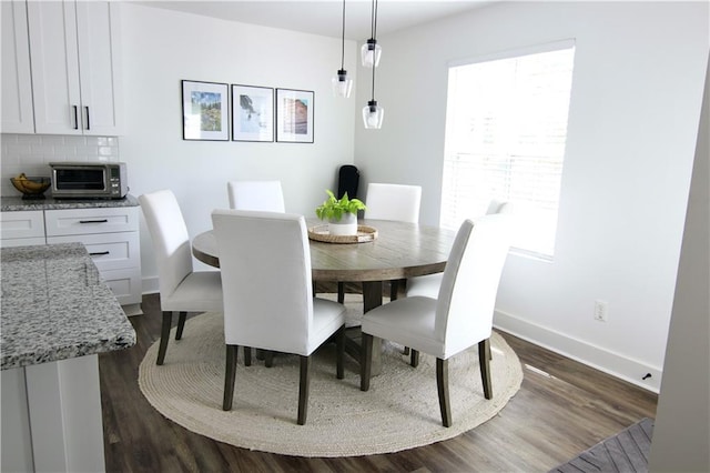 living area featuring ceiling fan, a fireplace, vaulted ceiling, baseboards, and dark wood-style flooring