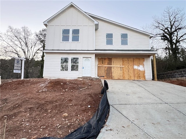 view of front of property featuring board and batten siding and driveway