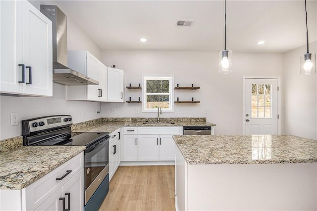 kitchen featuring visible vents, open shelves, a sink, stainless steel appliances, and wall chimney exhaust hood