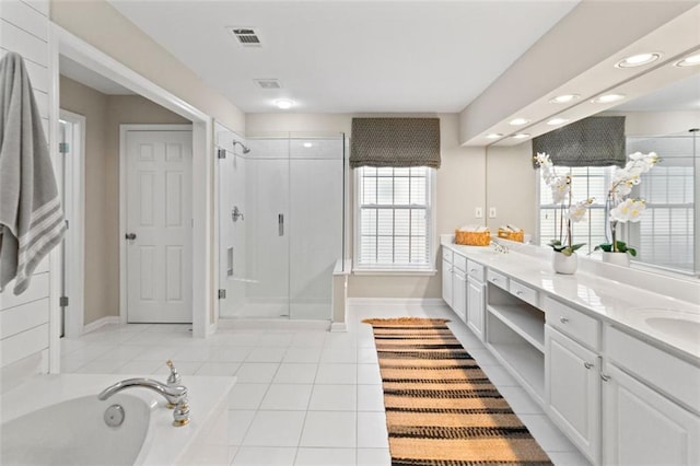 full bath with a sink, double vanity, a shower stall, and tile patterned floors