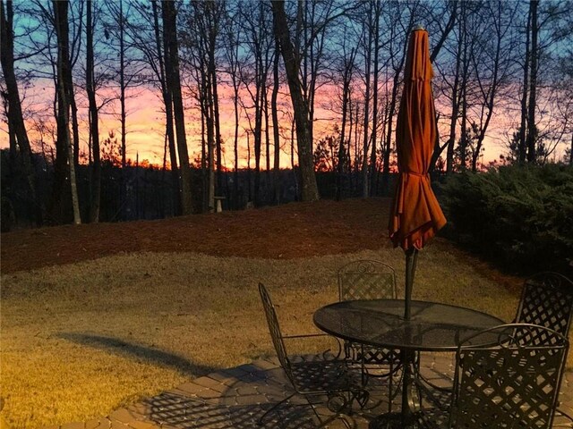 patio terrace at dusk with a yard