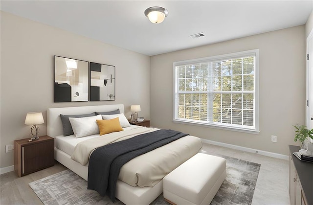 bedroom featuring baseboards and visible vents