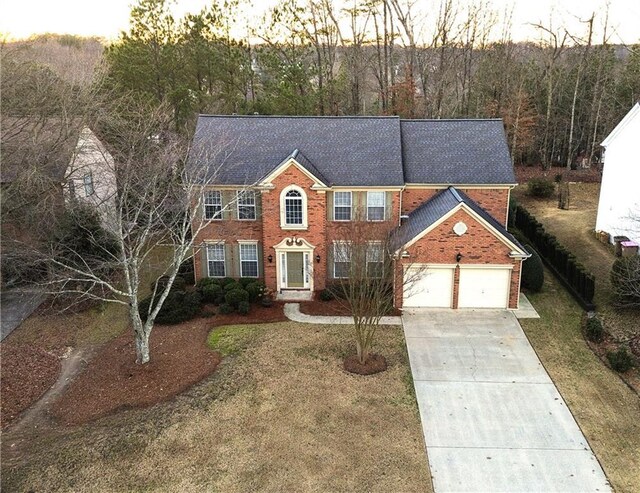 view of front of home with a front yard and a garage