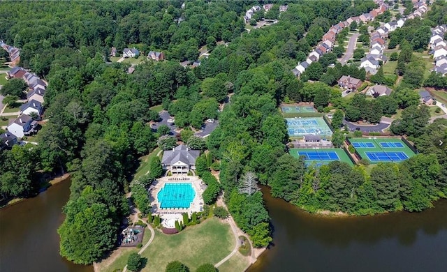 drone / aerial view featuring a water view and a wooded view