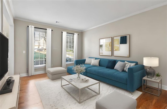 living room featuring baseboards, wood finished floors, visible vents, and crown molding