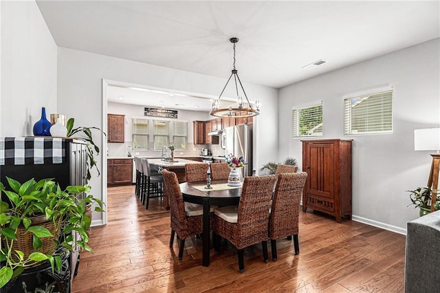1000 Eight Knot Ct, Greensboro, GA 30642 - dining area featuring hardwood / wood-style floors, a chandelier, and healthy amount of natural light
