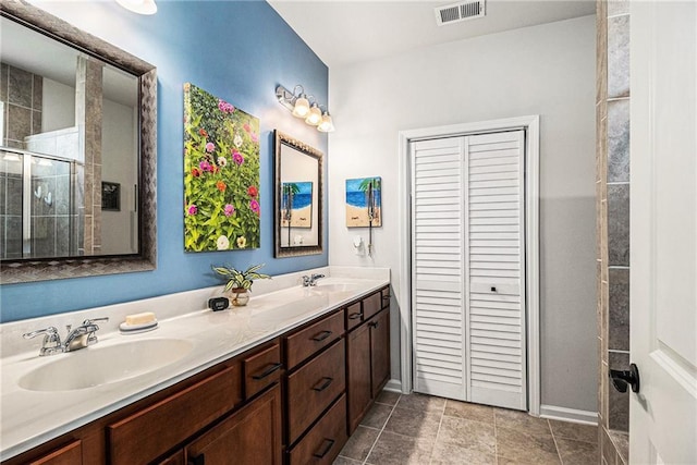 1000 Eight Knot Ct, Greensboro, GA 30642 - bathroom with double vanity, tiled shower, a closet, and baseboards